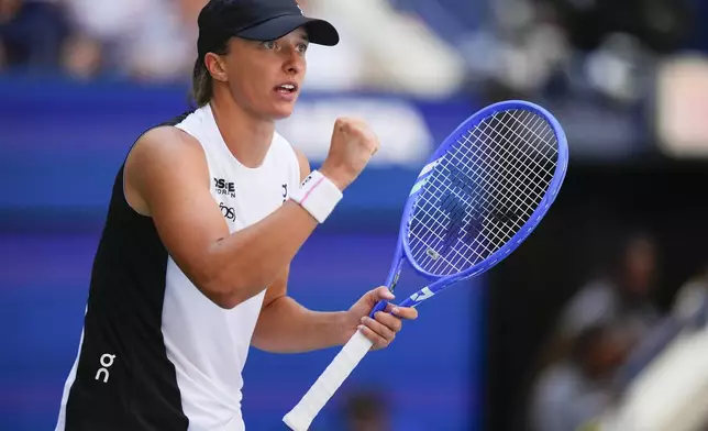 Iga Swiatek, of Poland, reacts after scoring a point against Emiliana Arango, of Colombia, during the first round of the US Open tennis championships, Tuesday, Aug. 26, 2025, in New York. (AP Photo/Yuki Iwamura)