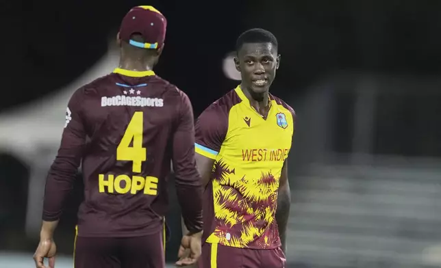 West Indies' Shamar Joseph, right, chats with Shai Hope during the first Twenty20 cricket match between West Indies and Pakistan, in Lauderhill, Fla., Thursday, July 31, 2025. (AP Photo/Lynne Sladky)