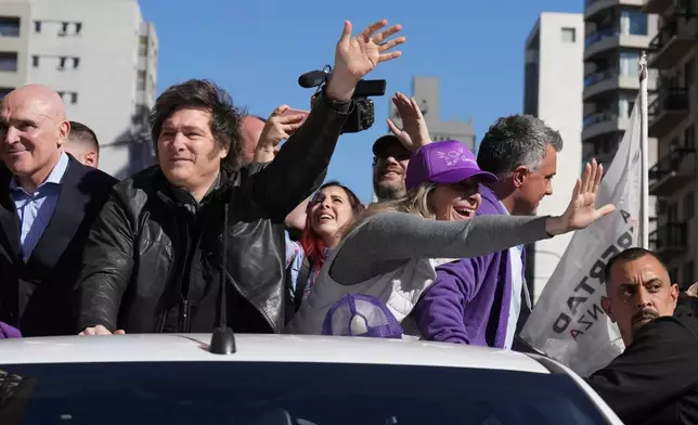 Argentine President Javier Milei and his sister, Secretary General of the Presidency, Karina Milei attend a campaign rally ahead of legislative provincial elections in Lomas de Zamora, Argentina, Wednesday, Aug. 27, 2025. (AP Photo/Natacha Pisarenko)