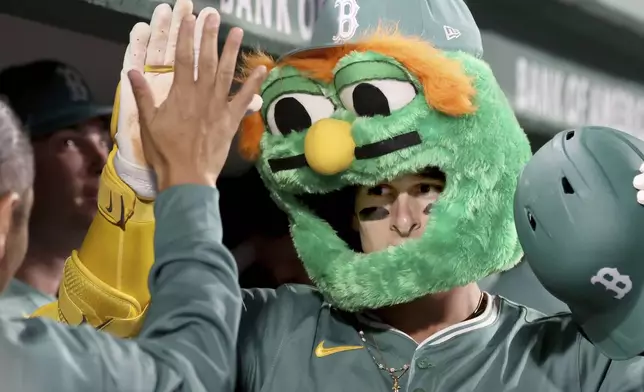 Boston Red Sox's Roman Anthony celebrates in the dugout after hitting a home run during the fifth inning of a baseball game against the Pittsburgh Pirates, Friday, Aug. 29, 2025, in Boston. (AP Photo/Mark Stockwell)