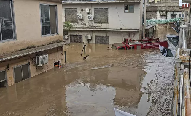 A vehicle of firefighters department submerged in a floodwater following flash flooding due to heavy rains at a neighbourhood of Mingora, the main town of Swat Valley, northwestern Pakistan, Friday, Aug. 15, 2025. (AP Photo/Sherin Zada)