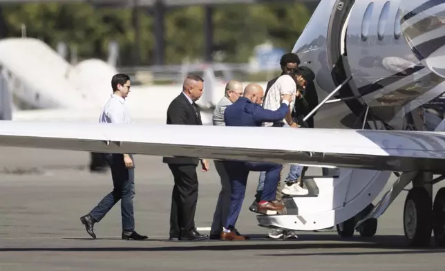 Harjinder Singh is escorted onto an airplane by Florida Lt. Gov. Jay Collins and law enforcement on Thursday, Aug. 21, 2025, in Stockton, Calif. (AP Photo/Benjamin Fanjoy)
