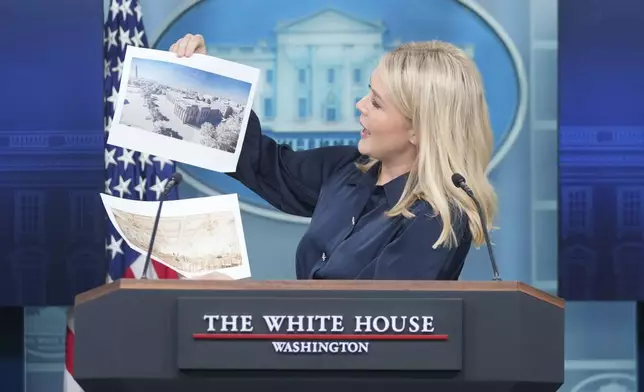 White House press secretary Karoline Leavitt holds up photos of the planned new White House ballroom during a press briefing at the White House in Washington, Thursday, July 31, 2025. (AP Photo/Mark Schiefelbein)
