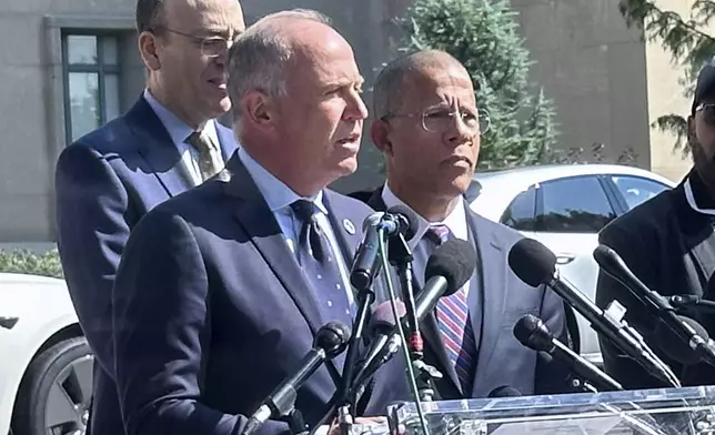 FILE - Brian Schwalb, attorney general for the District of Columbia, center, speaks outside the federal courthouse, Sept. 3, 2024 in Washington. (AP Photo/Lindsay Whitehurst, File)