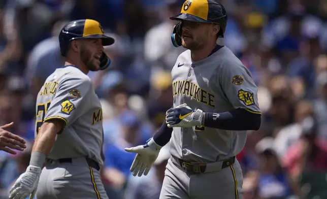 Milwaukee Brewers' Brice Turang (2), right, celebrates after hitting a two-run home run during the second inning of a baseball game against the Chicago Cubs, Thursday, Aug. 21, 2025, in Chicago. (AP Photo/Erin Hooley)