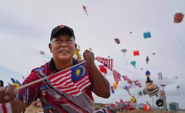 A participant from Malaysia flies kites during the Colombo International Kite Festival in Colombo, Sri Lanka, Saturday, Aug. 23, 2025. (AP Photo/Eranga Jayawardena)