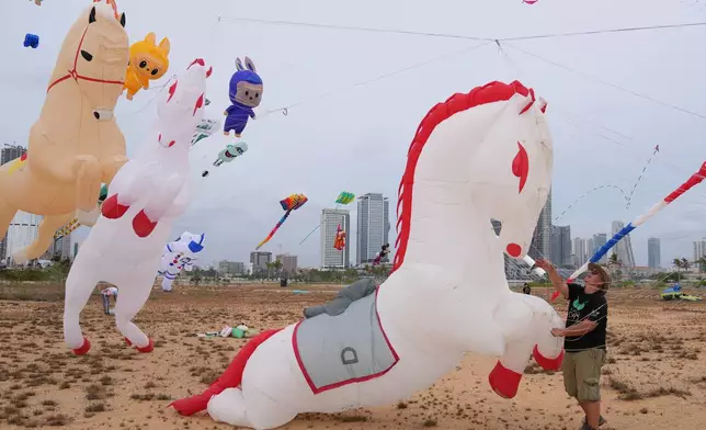 A participant from France prepares to fly his horse-shaped kite during the Colombo International Kite Festival in Colombo, Sri Lanka, Saturday, Aug. 23, 2025. (AP Photo/Eranga Jayawardena)