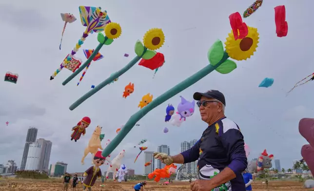 A participant flies his kite during the Colombo International Kite Festival in Colombo, Sri Lanka, Saturday, Aug. 23, 2025. (AP Photo/Eranga Jayawardena)