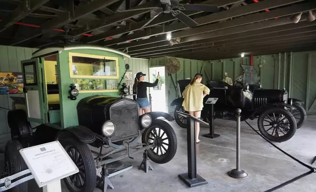 Visitors view Ford vehicles designed by Henry Ford at the Edison and Ford Winter Estates, Saturday, Aug. 9, 2025, in Fort Myers, Fla. Edison's friend, Henry Ford, purchased the adjoining property in 1916. (AP Photo/Lynne Sladky)