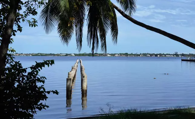 The remains of the Edison pier are shown along the Caloosahatchee River in front of the Edison and Ford Winter Estates, Saturday, Aug. 9, 2025, in Fort Myers, Fla. (AP Photo/Lynne Sladky)