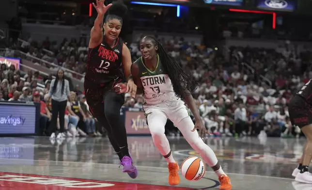 Seattle Storm forward Ezi Magbegor (13) goes to the basket against Indiana Fever forward Damiris Dantas (12) during the first half of a WNBA basketball game, Tuesday, Aug. 26, 2025, in Indianapolis. (AP Photo/Darron Cummings)