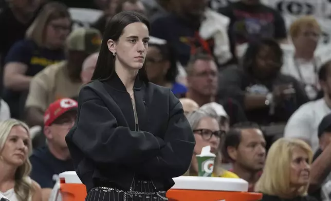 Indiana Fever guard Caitlin Clark watches during the first half of a WNBA basketball game against the Seattle Storm, Tuesday, Aug. 26, 2025, in Indianapolis. (AP Photo/Darron Cummings)