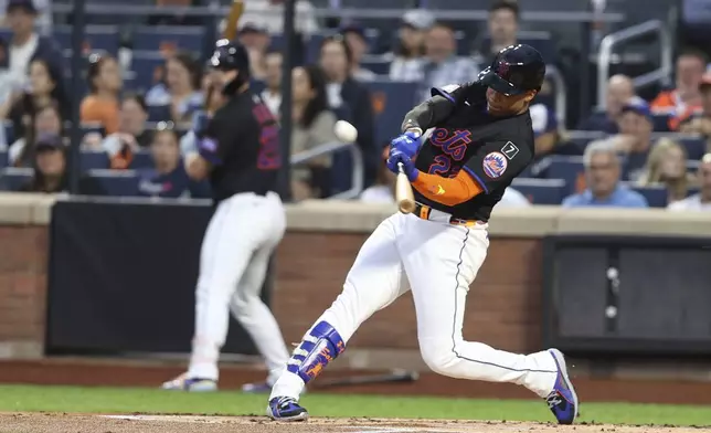 New York Mets' Juan Soto hits a two-run home run, which also scored Francisco Lindor, during the first inning of a baseball game against the Miami Marlins, Friday, Aug. 29, 2025, in New York. (AP Photo/Pamela Smith)