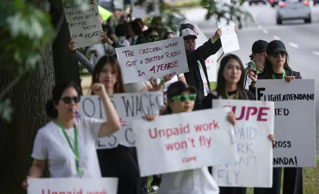 Striking Air Canada flight attendants rally at Vancouver International Airport, in Richmond, British Columbia, Monday, Aug. 18, 2025. (Darryl Dyck/The Canadian Press via AP)