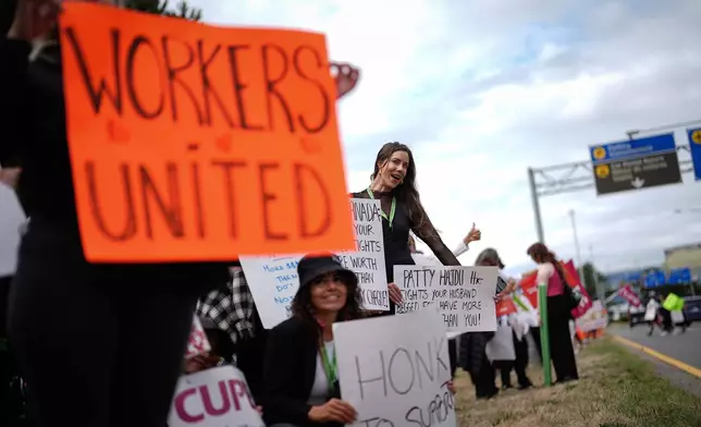 Striking Air Canada flight attendants rally at Vancouver International Airport, in Richmond, British Columbia, Monday, Aug. 18, 2025. (Darryl Dyck/The Canadian Press via AP)