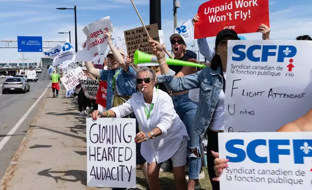 Air Canada flight attendants and supporters picket outside Montreal-Pierre Elliott Trudeau International Airport in Dorval, Quebec, Monday, Aug. 18, 2025. (Christinne Muschi/The Canadian Press via AP)