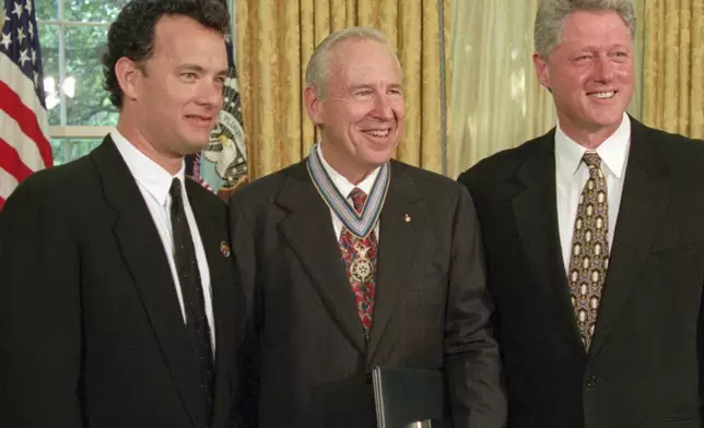 FILE - President Clinton stands with actor Tom Hanks, left, and former astronaut James Lovell in the Oval Office of the White House Wednesday, July 26, 1995, after presenting Lovell with the Congressional Space Medal of Honor. Hanks portrayed Lovell in the movie "Apollo 13." (AP Photo/Wilfredo Lee, File)