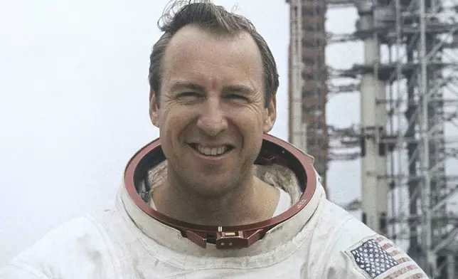 FILE - In this photo provided by NASA, astronaut James Lovell, Apollo 13 commander poses for a portrait in his space suit, Feb. 16, 1970. (AP Photo/NASA, File)