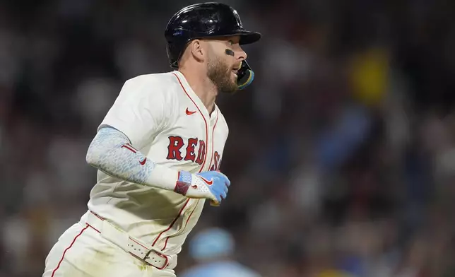 Boston Red Sox shortstop Trevor Story heads for first, driving in two runs in the sixth inning of a baseball game against Kansas City Royals, Tuesday, Aug. 5, 2025, in Boston. (AP Photo/Robert F. Bukaty)