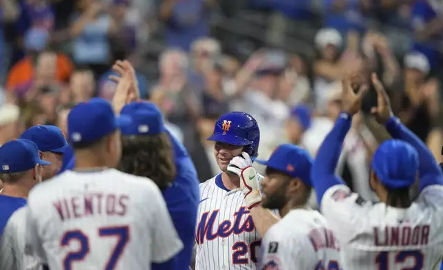 New York Mets' Pete Alonso (20) celebrates with teammates after hitting a two-run home run during the third inning of a baseball game against the Atlanta Braves Tuesday, Aug. 12, 2025, in New York. (AP Photo/Frank Franklin II)