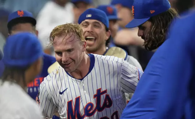 New York Mets' Pete Alonso (20) celebrates with teammates after hitting a two-run home run during the third inning of a baseball game against the Atlanta Braves Tuesday, Aug. 12, 2025, in New York. (AP Photo/Frank Franklin II)