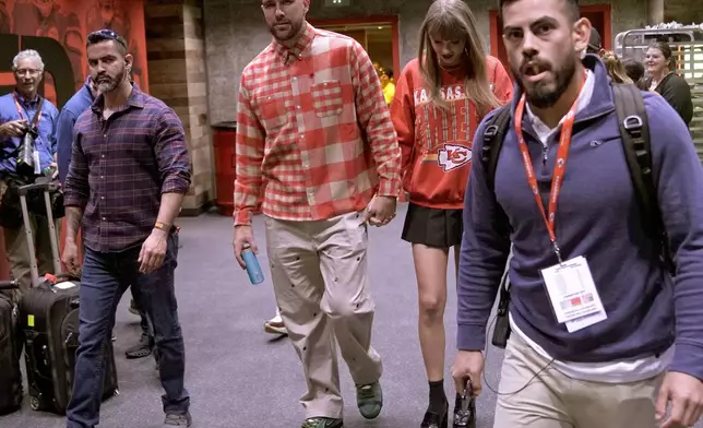 FILE - Kansas City Chiefs tight end Travis Kelce, center left, and singer Taylor Swift leave Arrowhead stadium after an NFL football game between the Chiefs and the Los Angeles Chargers in Kansas City, Mo., Oct. 22, 2023. (AP Photo/Charlie Riedel, File)