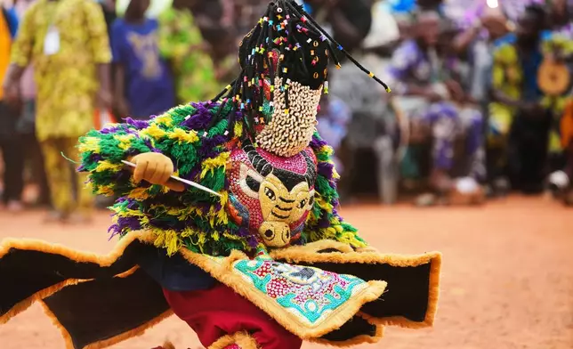 A man dressed in a costume dances during the mask festival in Porto Novo, Benin , Saturday, Aug. 2, 2025. (AP Photo/Sunday Alamba)