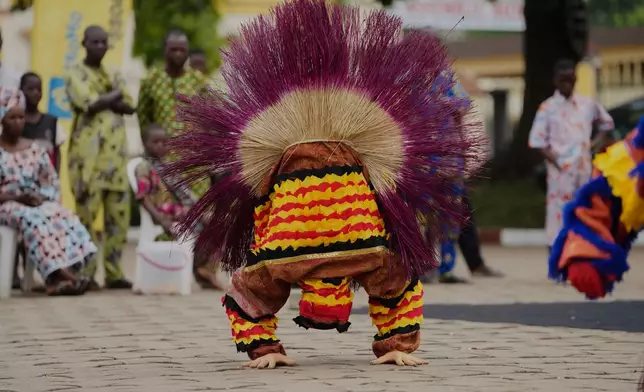 A man dressed in a costume performs during the mask festival in Porto-Novo, Benin , Sunday, Aug. 3, 2025. (AP Photo/Sunday Alamba)