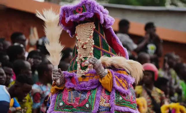 A man dressed in a costume performs during the mask festival in Porto Novo, Benin , Saturday, Aug. 2, 2025. (AP Photo/Sunday Alamba)