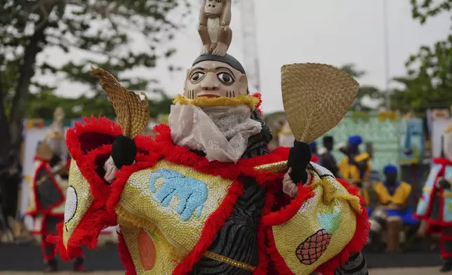 A man dressed in a costume dances during the mask festival in Porto Novo, Benin , Saturday, Aug. 2, 2025. (AP Photo/Sunday Alamba)