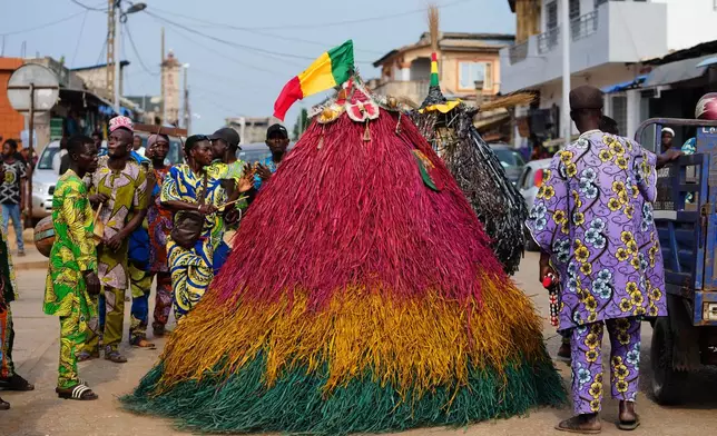 Zangbeto, a Voodoo guardian also known as "guardians of the night," performs during a mask festival in Porto Novo, Benin , Saturday, Aug. 2, 2025. (AP Photo/Sunday Alamba)