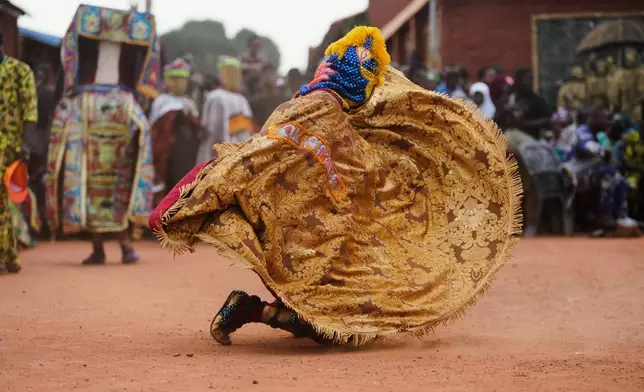 A man dress in costumes dance during the mask festival in Porto Novo, Benin , Saturday, Aug. 2, 2025. (AP Photo/Sunday Alamba)