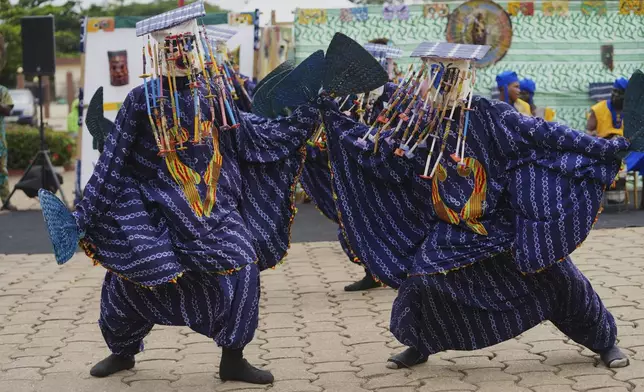 People dressed in costumes perform during the mask festival in Porto-Novo, Benin , Sunday, Aug. 3, 2025. (AP Photo/Sunday Alamba)