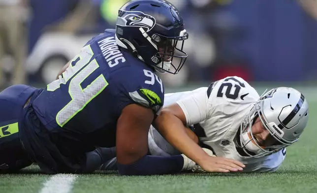 Seattle Seahawks defensive end Mike Morris (94) forces an incomplete against Las Vegas Raiders quarterback Aidan O'Connell (12) during the first half of an NFL preseason football game Thursday, Aug. 7, 2025, in Seattle. (AP Photo/Lindsey Wasson)