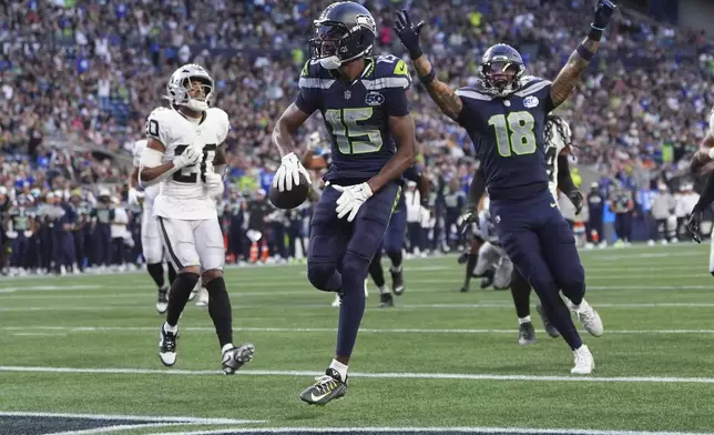 Seattle Seahawks wide receiver Tory Horton (15) scores a touchdown during the first half of an NFL preseason football game against the Las Vegas Raiders, Thursday, Aug. 7, 2025, in Seattle. (AP Photo/Lindsey Wasson)
