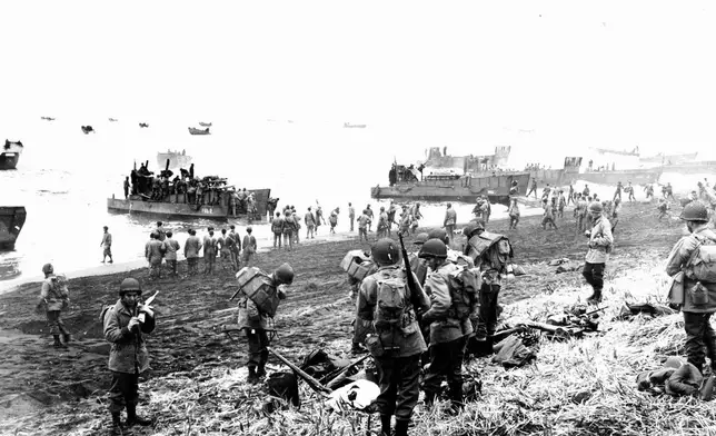 FILE - In this May 26, 1943 file photo released by the U.S. Navy, American soldiers and equipment land on the black volcanic beach during World War II at Massacre Bay on Attu Island, part of the Aleutian Islands of Alaska. (U.S. Navy via AP, File)