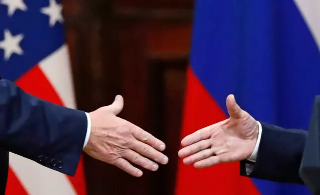 FILE - U.S. President Donald Trump shakes hand with Russian President Vladimir Putin at the end of the press conference after their meeting at the Presidential Palace in Helsinki, Finland, July 16, 2018. (AP Photo/Alexander Zemlianichenko, File)