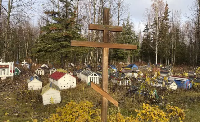 FILE - The cemetery at St. Nicholas Church in Eklutna, Alaska, features a mixture of Russian Orthodox conventions like crosses featuring three cross beams and the Dena'ina Athabascan tradition of erecting spirit homes above the graves, on Oct. 13, 2023. (AP Photo/Mark Thiessen, File)