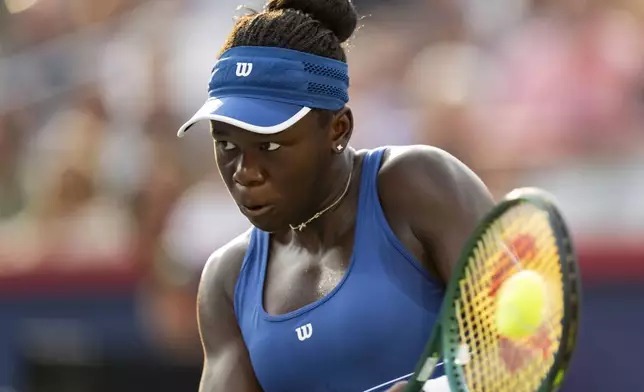 Victoria Mboko, of Canada, hits a return to Naomi Osaka, of Japan, during finals action at the National Bank Open women's tennis tournament in Montreal, Thursday, Aug. 7, 2025. (Christinne Muschi/The Canadian Press via AP)