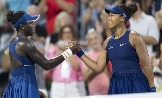 Victoria Mboko, left, of Canada, is congratulated after her win by Naomi Osaka, right, of Japan, in final action at the National Bank Open women's tennis tournament in Montreal, Thursday, Aug. 7, 2025. (Christopher Katsarov/The Canadian Press via AP)