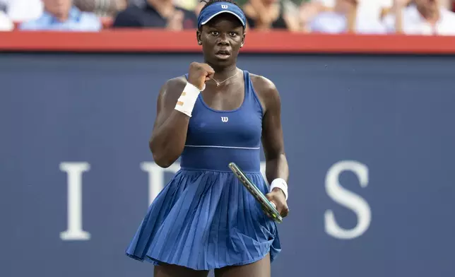 Victoria Mboko, of Canada, reacts during her match against Naomi Osaka, of Japan, during finals action at the National Bank Open women's tennis tournament in Montreal, Thursday, Aug. 7, 2025. (Christinne Muschi/The Canadian Press via AP)