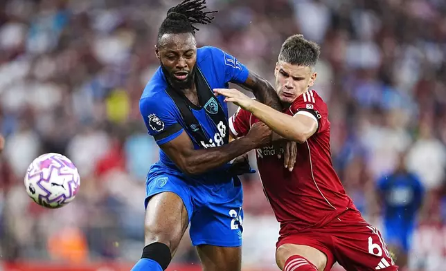 Bournemouth's Antoine Semenyo, left, and Liverpool's Milos Kerkez in action during the English Premier League soccer match between Liverpool and Bournemouth at Anfield, Liverpool, England, Friday Aug. 15, 2025. (Peter Byrne/PA via AP)