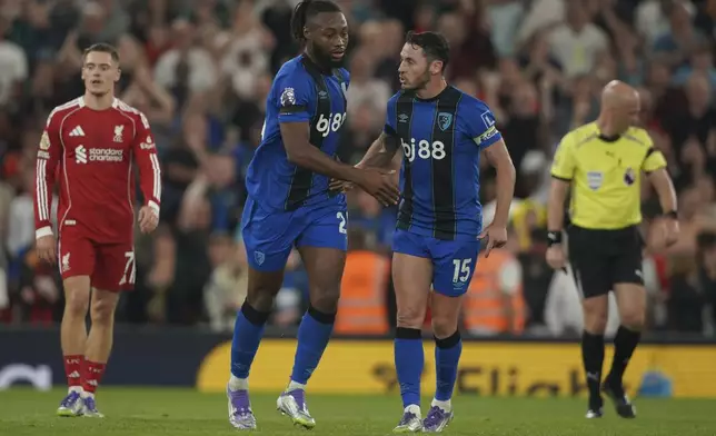 Bournemouth's Antoine Semenyo, centre left, celebrates with Bournemouth's Adam Smith after scoring his side's opening goal during the English Premier League soccer match between Liverpool and Bournemouth at Anfield stadium in Liverpool, England, Friday, Aug. 15, 2025. (AP Photo/Ian Hodgson)