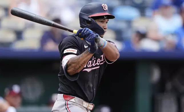 Washington Nationals' Daylen Lile watches his RBI single during the ninth inning of a baseball game against the Kansas City Royals, Wednesday, Aug. 13, 2025, in Kansas City, Mo. (AP Photo/Charlie Riedel)