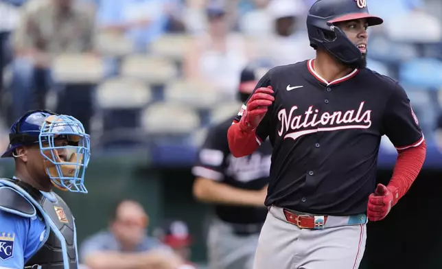 Washington Nationals' Luis Garcia Jr. crosses the plate to score on a single hit by Daylen Lile during the ninth inning of a baseball game against the Kansas City Royals, Wednesday, Aug. 13, 2025, in Kansas City, Mo. (AP Photo/Charlie Riedel)