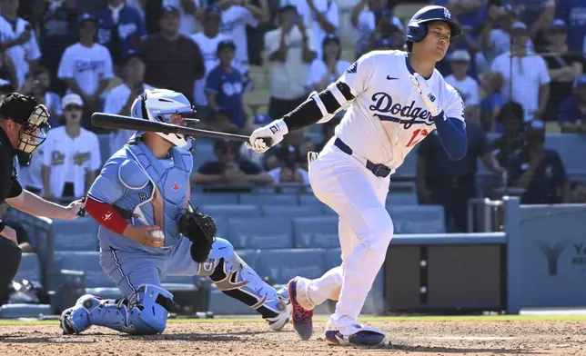 Los Angeles Dodgers' Shohei Ohtani strikes out with the bases loaded during the ninth inning of a baseball game against the Toronto Blue Jays, Sunday, Aug. 10, 2025, in Los Angeles. (AP Photo/Wally Skalij)