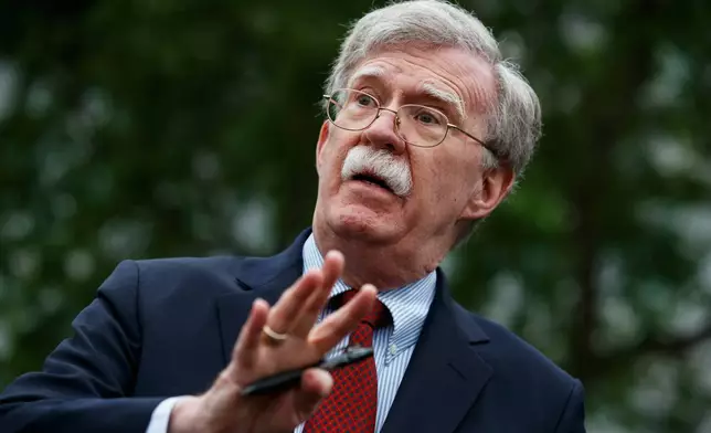 FILE - National security adviser John Bolton talks to reporters about Venezuela, outside the White House, May 1, 2019, in Washington. (AP Photo/Evan Vucci File)