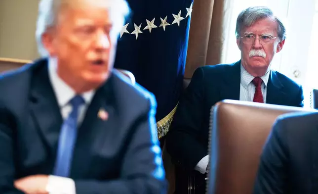 FILE - National security adviser John Bolton listens as President Donald Trump speaks during a cabinet meeting at the White House, April 9, 2018, in Washington. (AP Photo/Evan Vucci, File)
