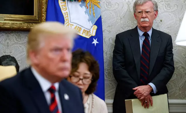FILE - President Donald Trump meets with South Korean President Moon Jae-In in the Oval Office of the White House, May 22, 2018, in Washington, as national security adviser John Bolton watches. (AP Photo/Evan Vucci, File)