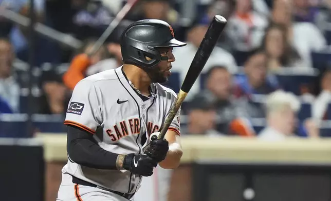 San Francisco Giants' Dominic Smith hits an RBI single during the 10th inning of a baseball game against the New York Mets Friday, Aug. 1, 2025, in New York. (AP Photo/Frank Franklin II)